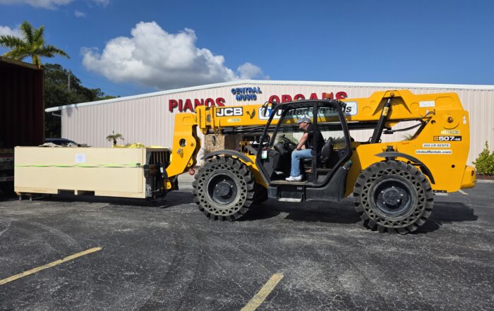 Central Music President Tim Newby unloads container with Ruffatti pipes for Espiritu Santo Catholic Church. Rodgers Ruffatti pipe-digital hybrid organ